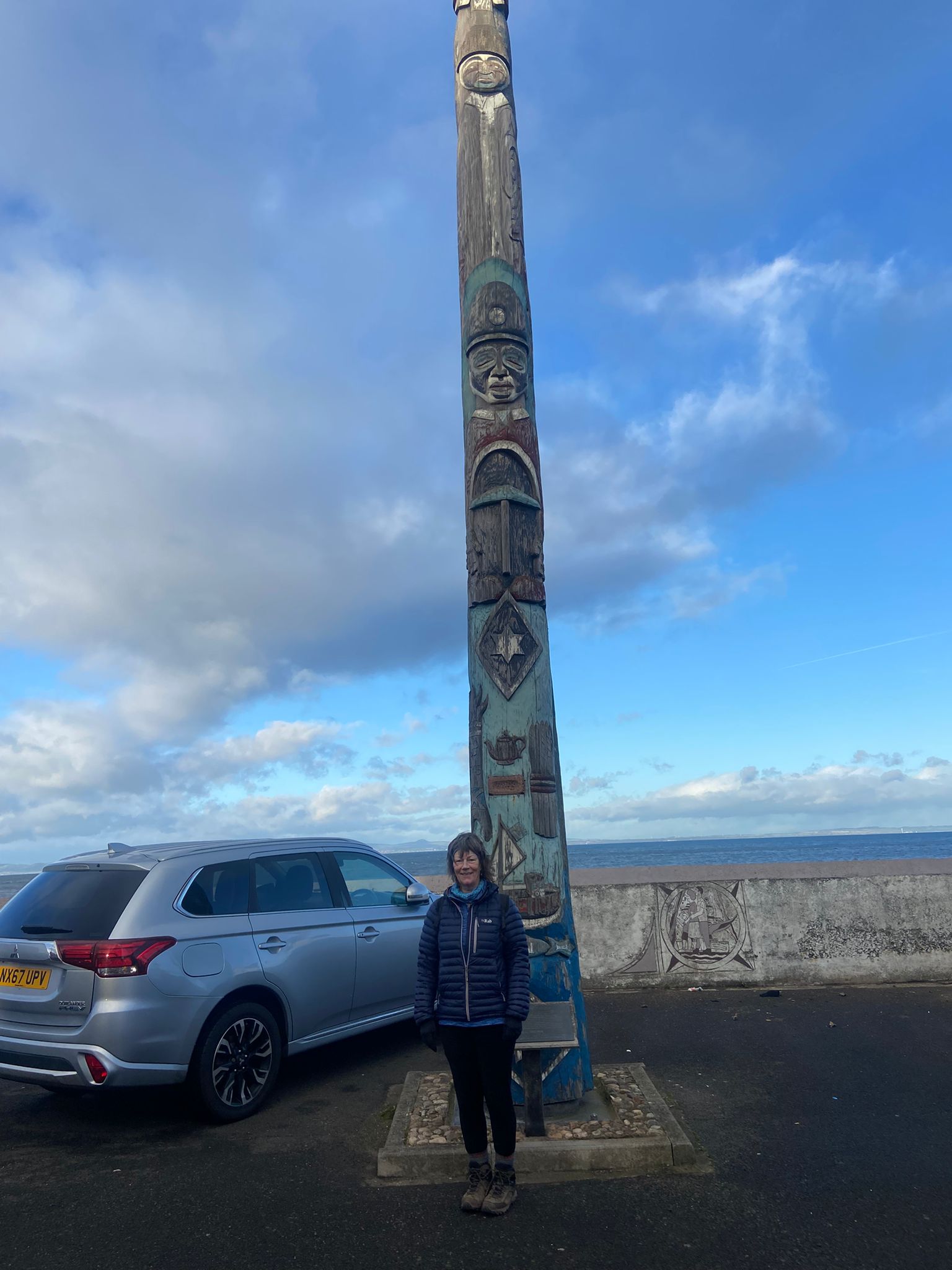 Judith about to climb a 32 feet British Columbia totem pole